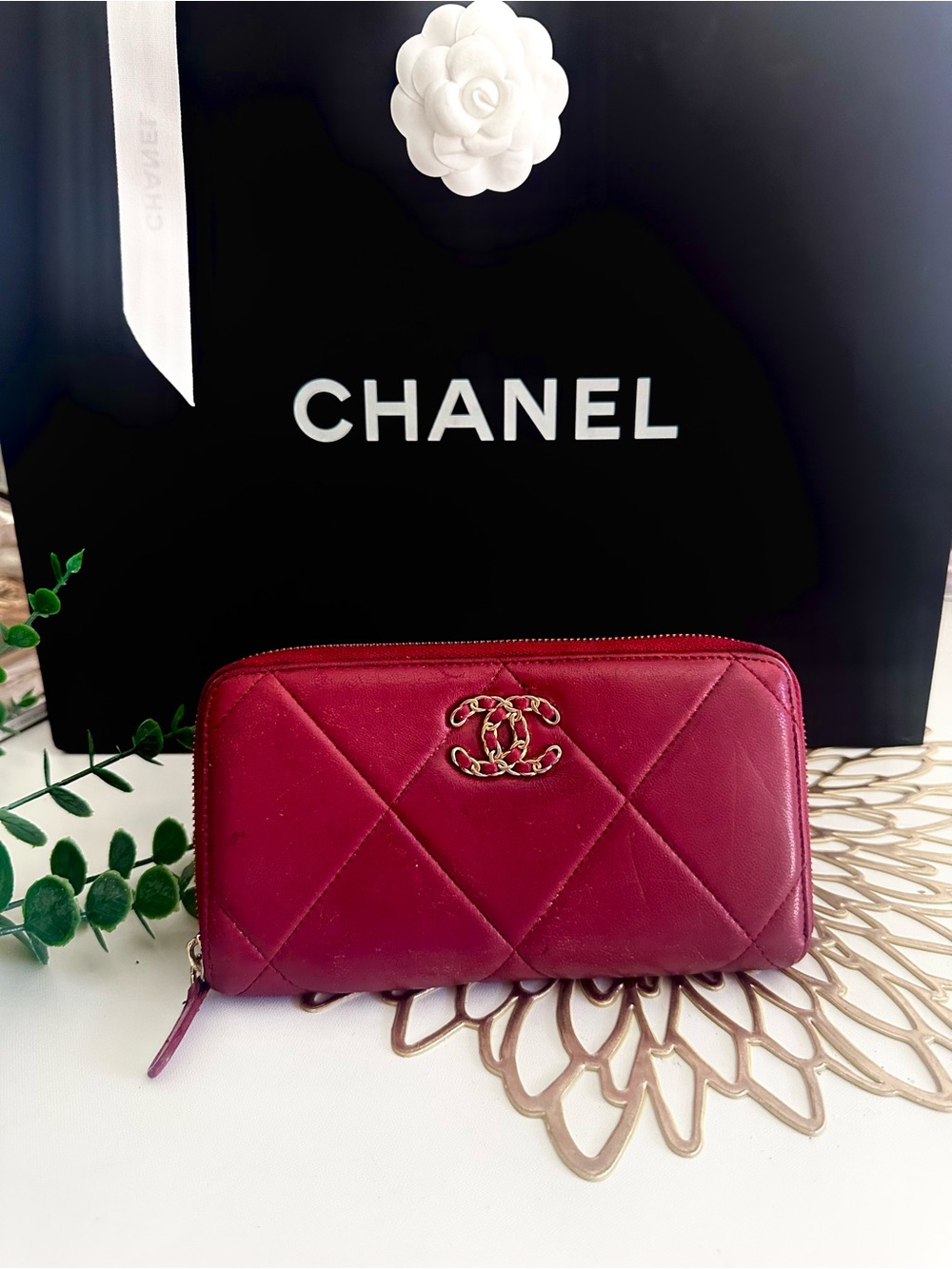 CHANEL Quilted Leather Clutch in Deep Berry with Gold Chain Logo